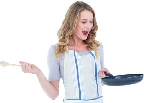 Smiling woman holding frying pan and wooden spoon 