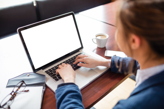 High angle view of female student using laptop on desk
