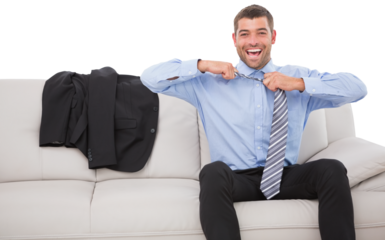 Cheerful businessman loosening his tie on sofa