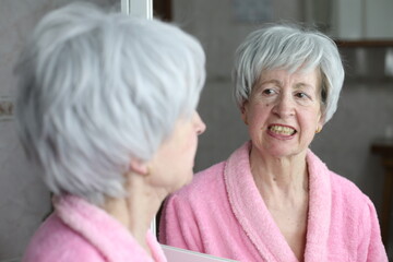 Senior woman unhappy with her yellow smile 