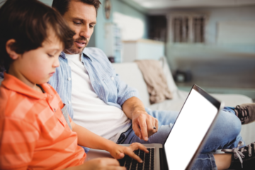 Father and son working on laptop