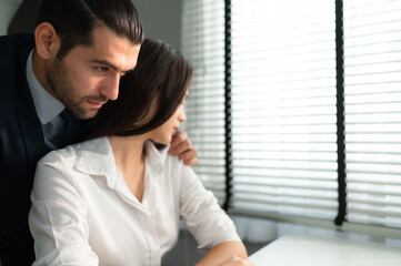 The executive is using his position of power to grope and touch the female employee's body, The concept of harassment and sex in the office.