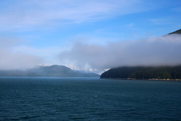 Mountain scenery appears from a fog bank in Icy Strait, Alaska, United States  