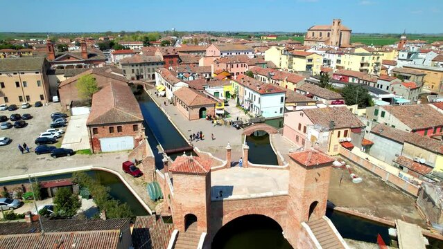 Comacchio - charming medieval villlage with street canals fanous as Little Venice in Emilia Romagna region in Italy, Aerial drone overflight 