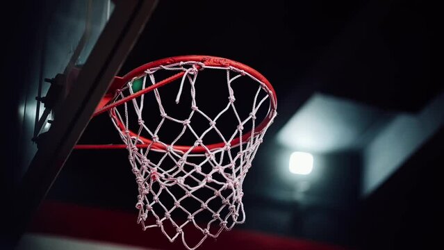 Basketball going into hoop after someone shoots the ball.