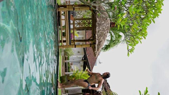  Man Does Round House High Kicks in the Water, vertical video, Slow Motion