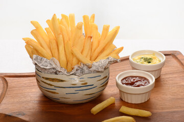 a bowl with a portion of fries mstarda sauce and katcup, on a white background
