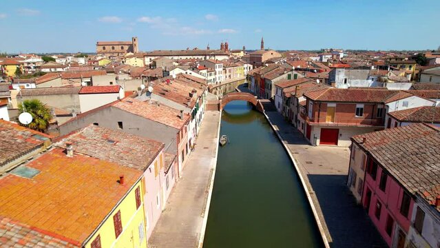 Little Venice Comacchio aerial view of narrow canals and historic bridges in medieval town Emilia Romagna Italy travel destination 4k drone footage along water street