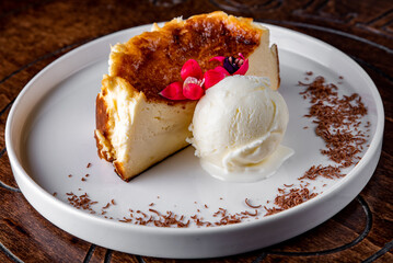 Basque Cheesecake on white dish with ice cream