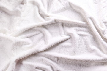 Macro shot white towel with visible fiber structure and wrinkles. A detailed close-up of towel fabric texture in monochromatic hues. Copy space for text, background.