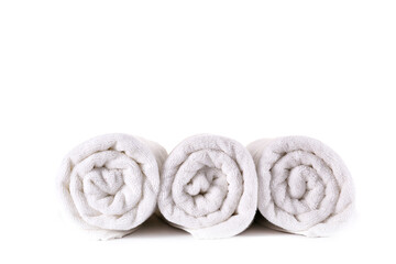 Obraz na płótnie Canvas Close up shot of three rolled towels isolated on white background. Copy space for text.