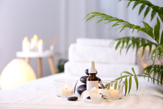 Stone therapy attributes for cosmetic procedures on a massage table. Symbolic objects for spa salon. Close up, copy space for text, top view, background.