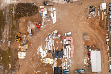 Drone photography of construction site and construction materials during spring day.