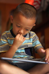 Boy bored playing computer games