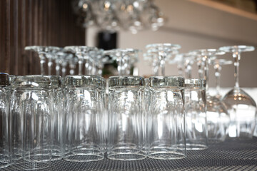 Row of drinking glasswares are prepared on the counter bar, ready for service to customer. Drink object, close-up and selective focus.