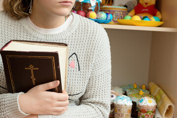 Portrait of a girl with a bible in her hands.