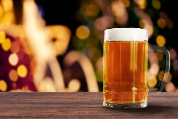A glass of cold beer on table in bar background.
