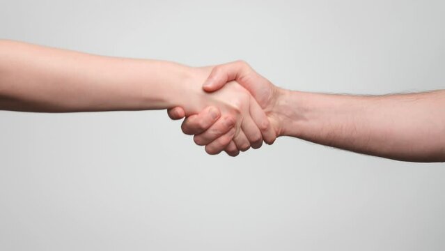 Man and woman shake hands, handshake close up. 4k, slow motion.