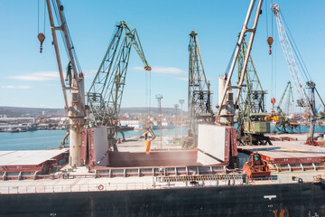 Aerial view Black Sea port Loading of dry cargo ship by grain cranes. Maritime grain Import and export concept