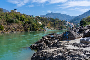 Beautiful River Ganga near Rishikesh with stones beach and Mountains. Pure natural clean river water.