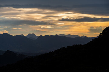 Majestic Mountain Range Silhouette at Dusk with Orange Sky