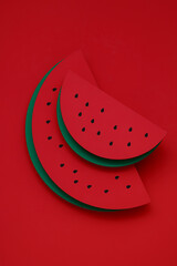 Geometric platform as a slice of watermelon. Semicircular green and red podiums on a red background. Stylish background for presentation food, vegetables, fruits, show products of market, empty mockup
