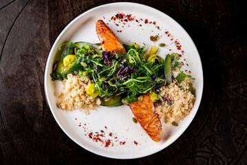 salmon fish with kinoa and vegetables salad