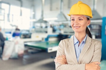 Happy young construction worker with on site outside.