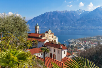 Early spring in Locarno, Ticino, Switzerland. View to Madonna del Sasso church and Lago Maggiore. - 592323305