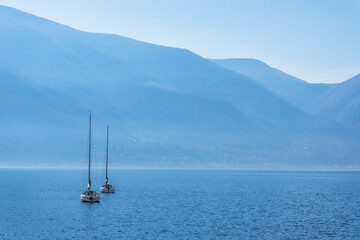 View to beautiful Lago Maggiore surrounded by blue mountains from Ascona, Switzerland - 592323355