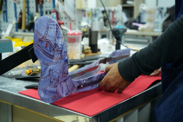 Orthopedic technician making prosthetic leg for disabilities people in workshop.