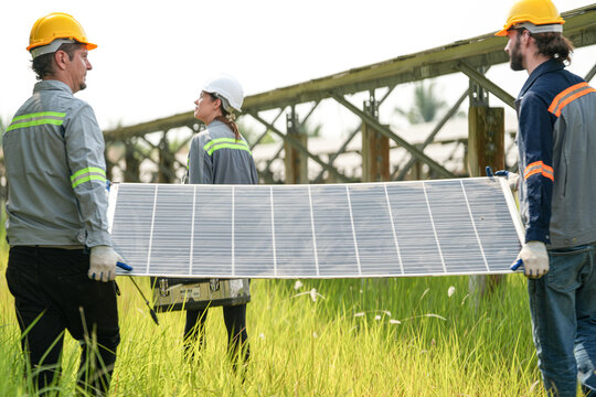 solor voltaic panels, indusrty engineer working at construction of solar farm.
