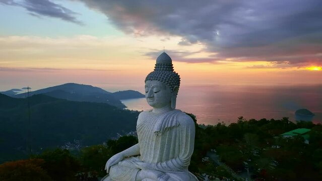 Aerial View big buddha on top of mountains at Phuket Thailand,Amazing sunset or sunrise sky over sea	