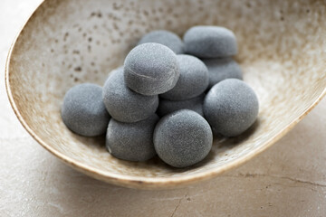 Close-up of a beige bowl with korean traditional mochi or chapssaltteok, horizontal shot, selective focus