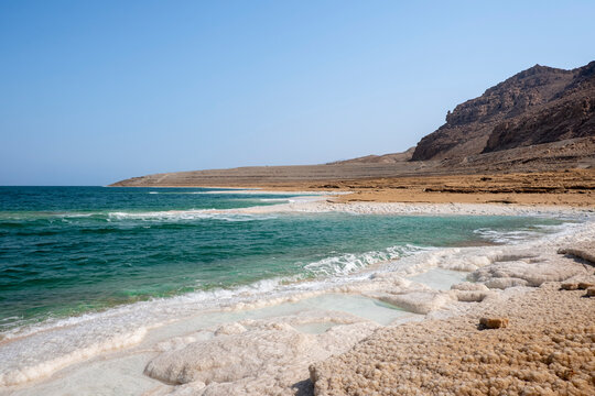 Beach with salt crystalized formation and turquoise water, The Dead Sea, Jordan, Middle East