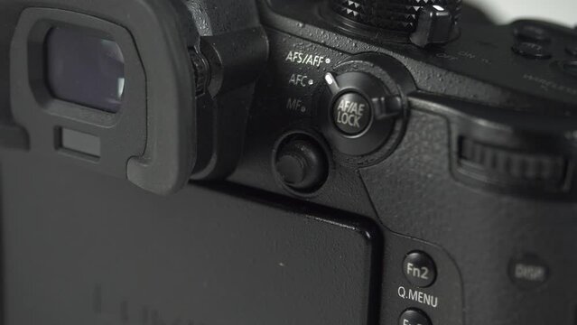 Professional camera close-up. Modern technology, professional equipment, black color, white background