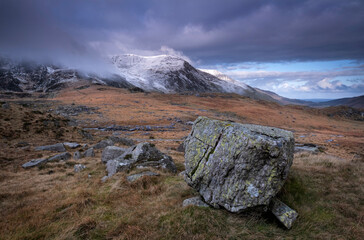 Glacial Erratic Boulder backed by the Glyderau Mountains, Cwm Idwal, Snowdonia National Park, Eryri, North Wales
