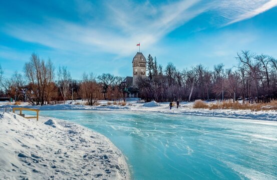 The Assiniboine Park Pavilion seen across the Duck Pond skating rink at Assiniboine Park, Winnipeg, Manitoba, Canada