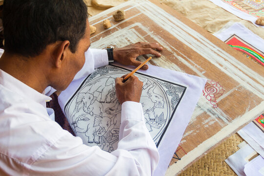 Artist drawing design featuring elephants on canvas, Bagan, Myanmar
