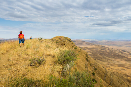 Tourists hiking along the border between Georgia and Azerbaijan near David Gareji Monastery, Udabno, Georgia