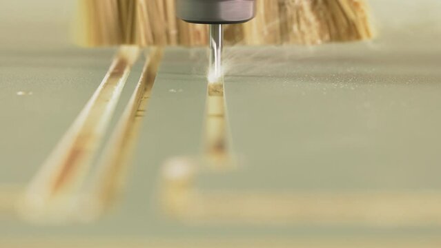 Turning cutter carves decor while brush removes sawdust at woodwork plant macro view. Automatic lathe machine tool operates with plywood