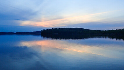 Boating at summer night on a lake in southern Finland