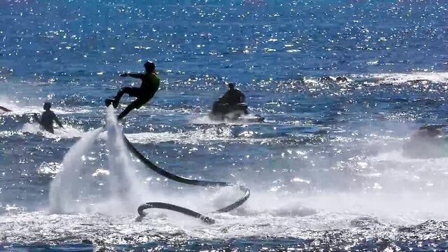 Flyboarding and sea riding on the sea near the island