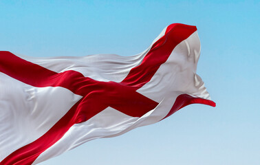 The state flag of Alabama waving in the wind on a clear day