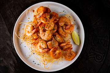 Whole fried big shrimps with seasonings in plate