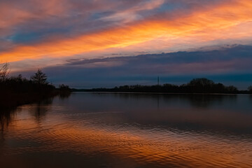 Obraz premium Sunset with reflections near Plattling, Isar, Bavaria, Germany