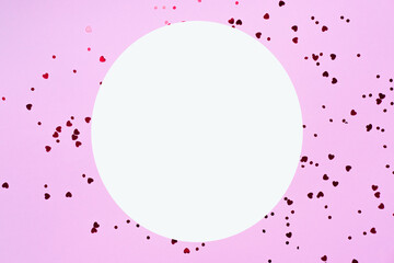 Mother's Day decoration concept. A picture of a white empty circle and sparkling heart-shaped...