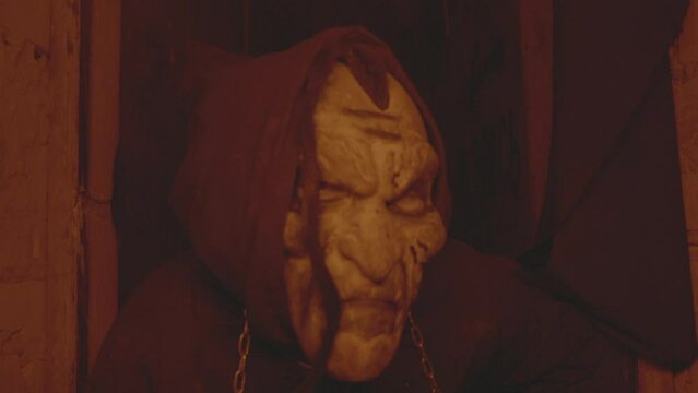 A murderer or an executioner in a terrible mask. A horror scene for Halloween or movie. High-quality Full HD footage with slow motion. A masked maniac looks into the camera. 