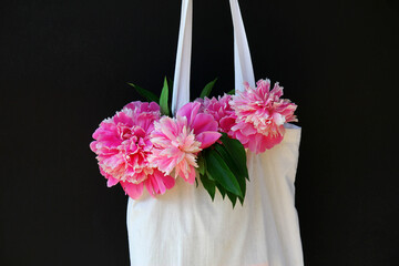 a bag with summer flowers peonies. summer mood, lifestyle.