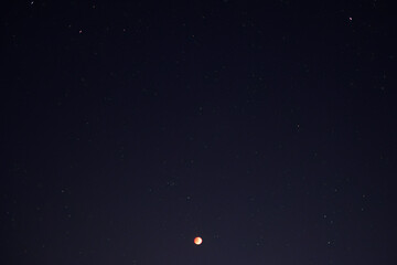 Lunar eclipse blood moon with starry in the night sky